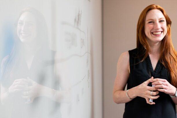 Woman next to a whiteboard
