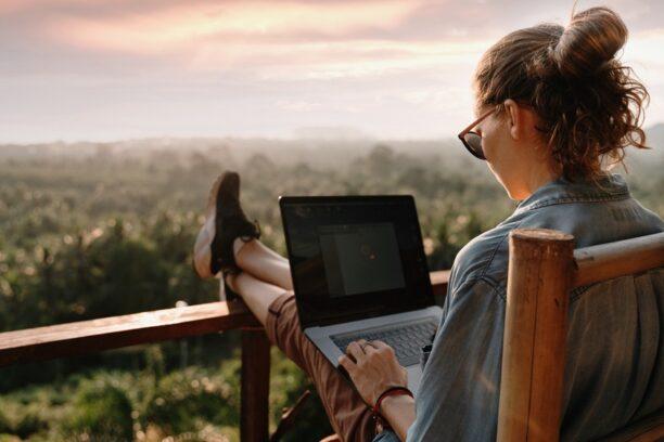 Woman on a laptop sitting outside