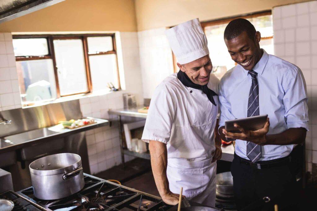 two hospitality workers in the kitchen