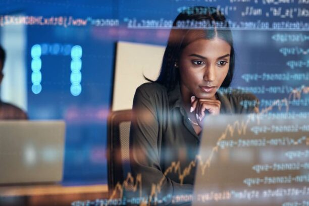 female IT worker focused on a laptop screen