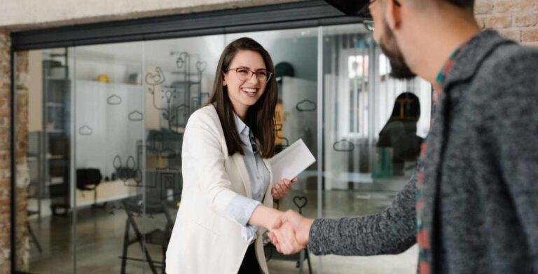 interviewer from a IT staffing agency shaking hands with interviewee