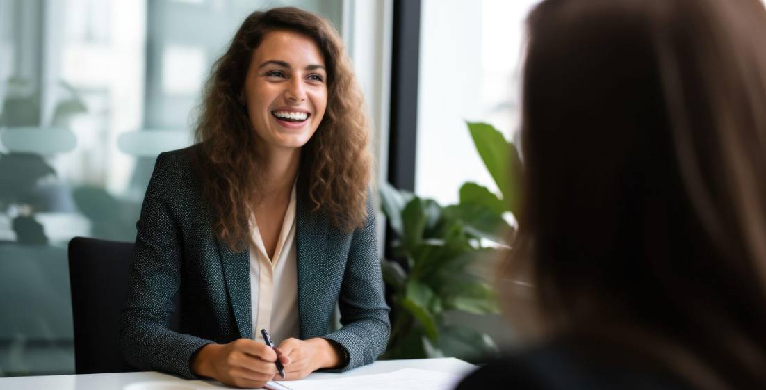 smiling female applicant in a job interview with a female interviewer