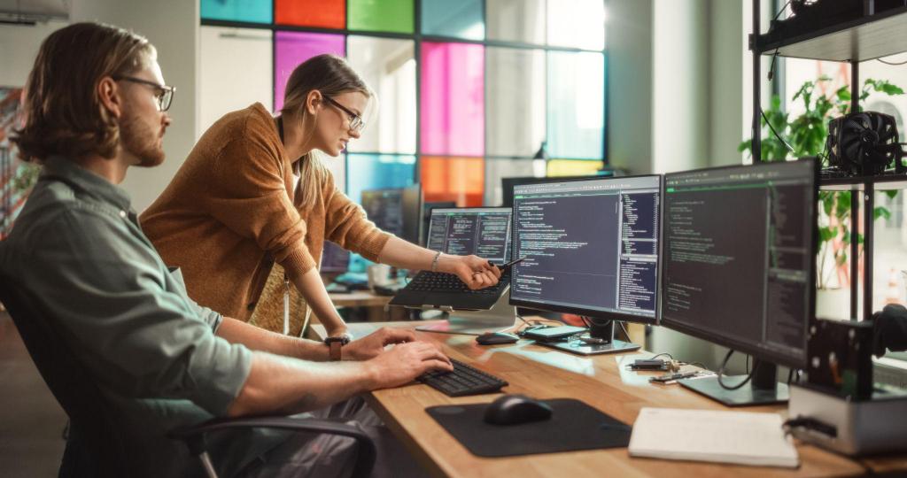 two coworkers going through data on a computer