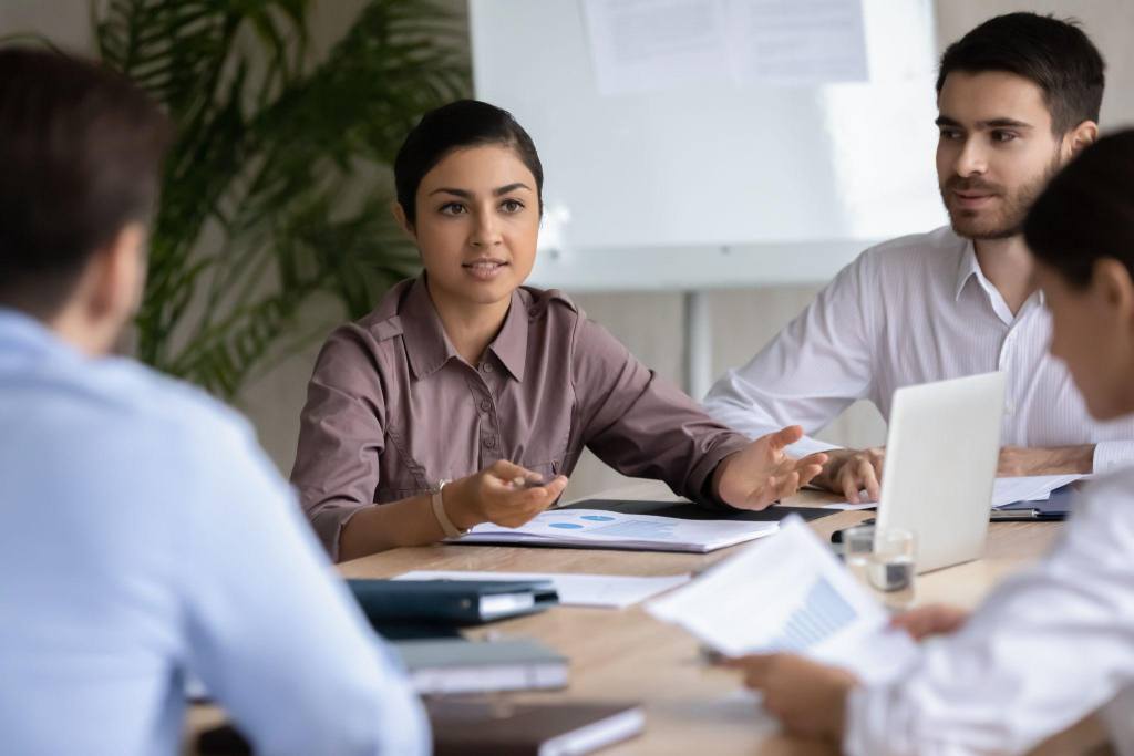 IT staff meeting led by a young female employee