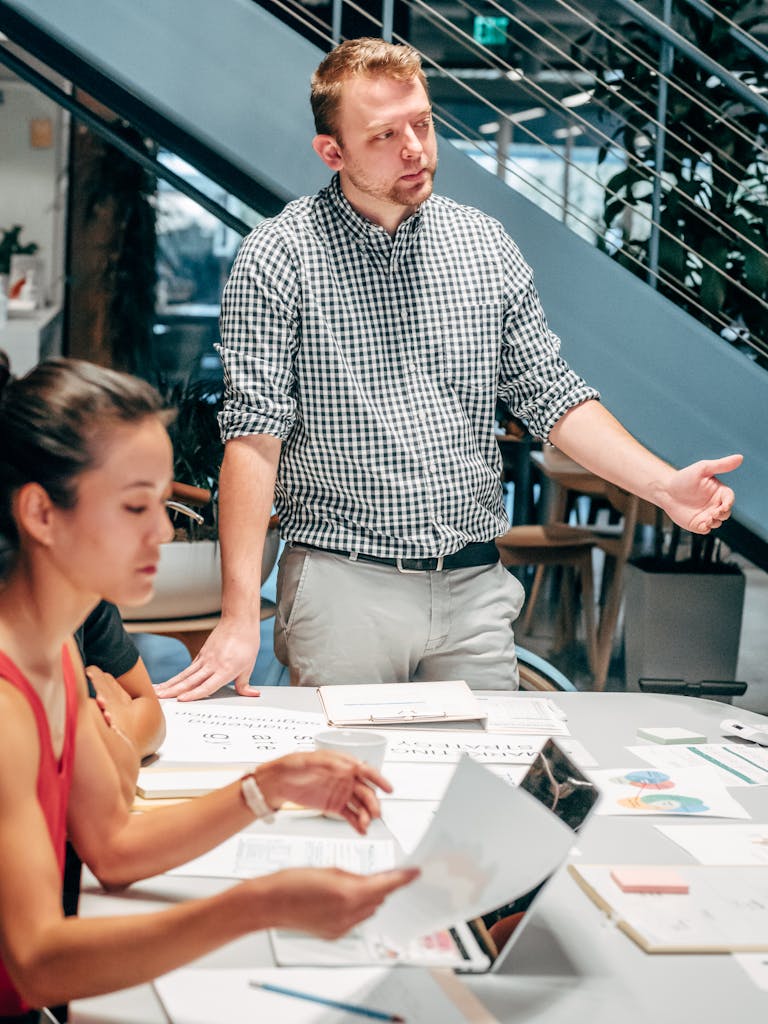 Diverse team collaborating in a modern office setting, discussing project details.