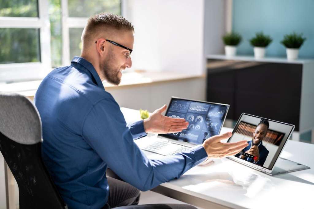 man sitting at his desk having a video call