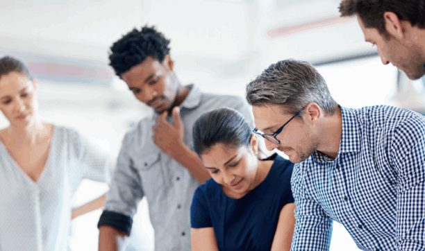 Group of colleagues looking at documents together.