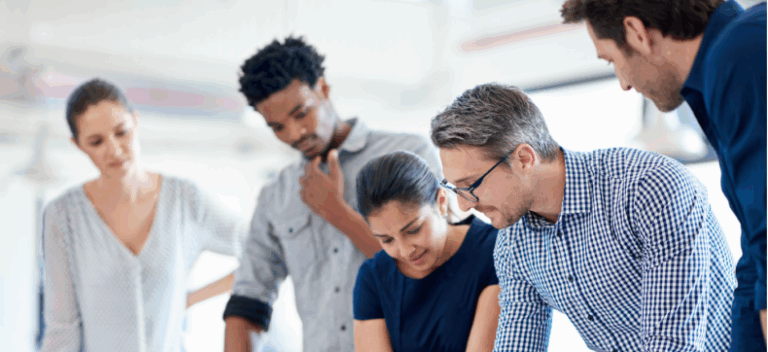 Group of colleagues looking at documents together.