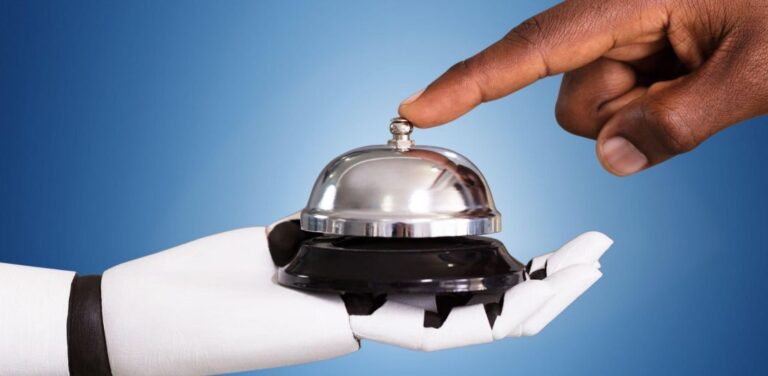 person ringing a bell held by a robot hand