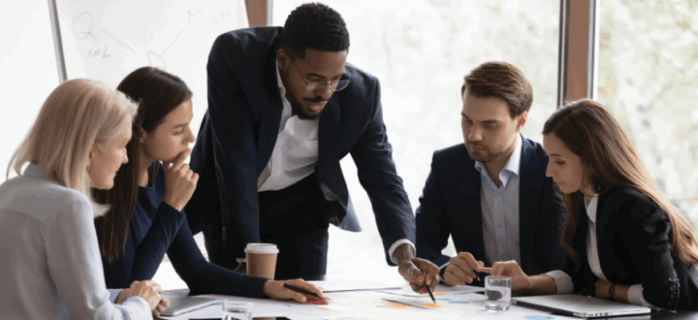 Group of professionals collaborating on project at conference table