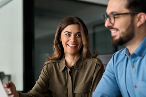 Two people collaborating on laptop