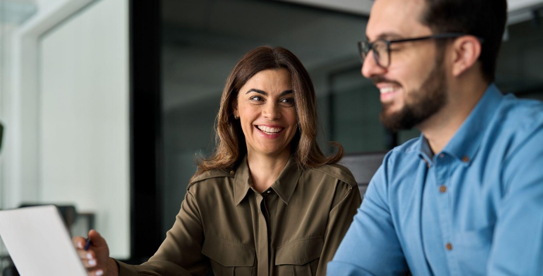 Two people collaborating on laptop