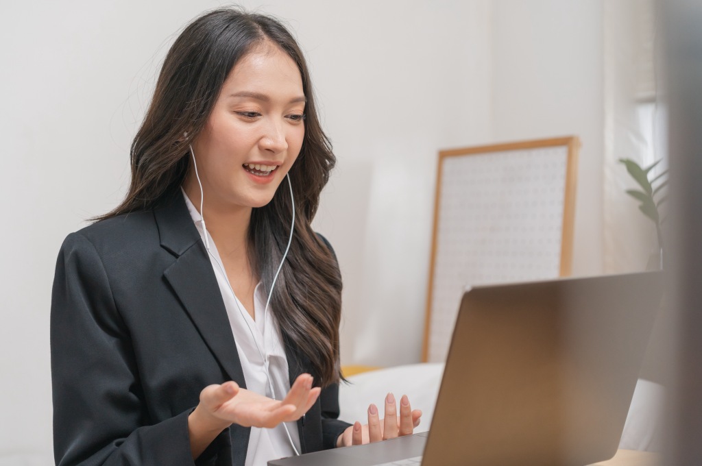 Professional Woman in Video Call on Laptop Smiling