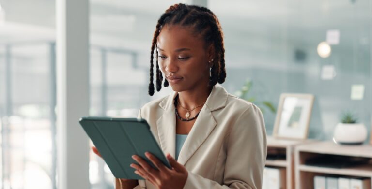 Professional Woman Reviewing Tablet in Modern Office