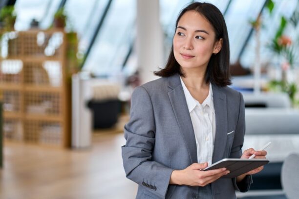 Professional Woman with Tablet in Bright Modern Office