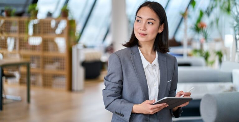 Professional Woman with Tablet in Bright Modern Office