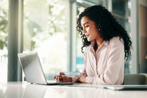 Professional Woman Working on Laptop in Modern Office