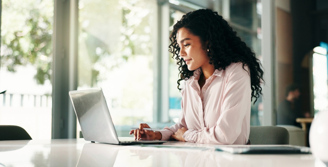 Professional Woman Working on Laptop in Modern Office