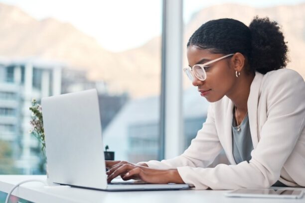 Professional Woman Working on Laptop with Mountain View
