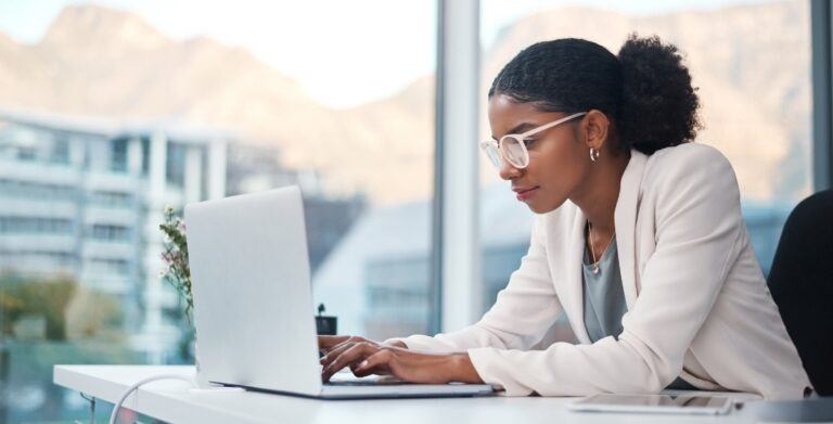 Professional Woman Working on Laptop with Mountain View