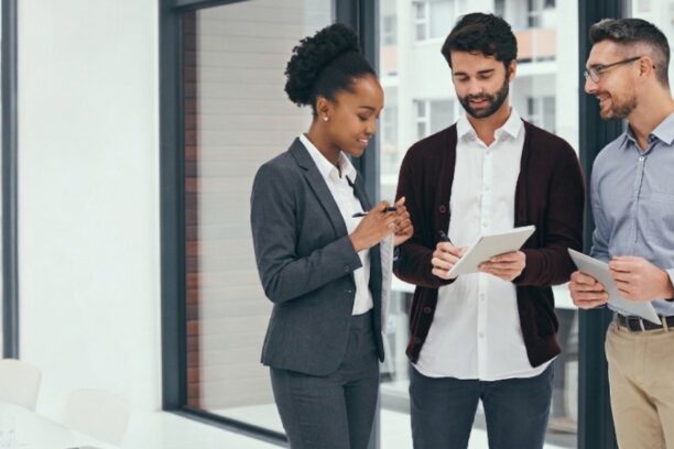 Three business professionals collaborating on app development team strategy