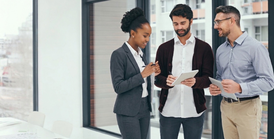Three business professionals collaborating on app development team strategy
